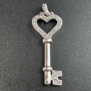18A- 925 Heart Key Pendant with clear stones not tested. No chain included.